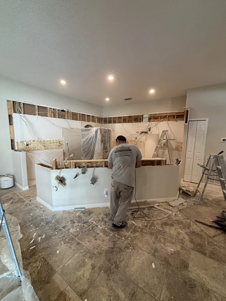 Ruko's crew member removing old cabinets during a kitchen remodel