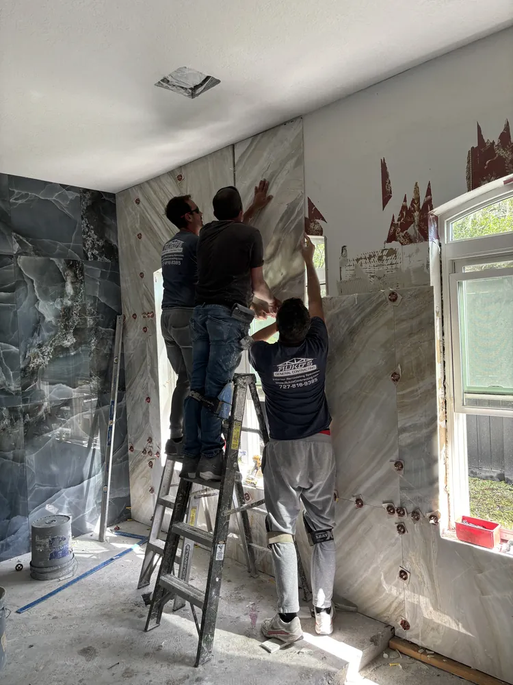 Three Ruko's crew members installing large-format porcelain wall panels