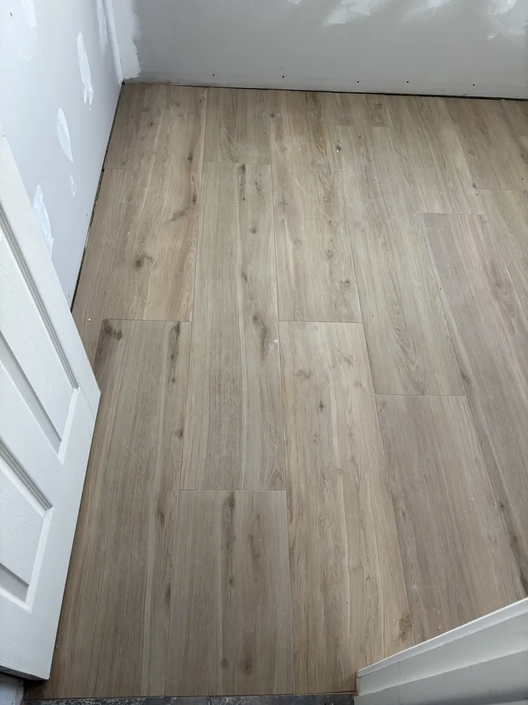 Light oak luxury vinyl plank flooring installed in a hallway