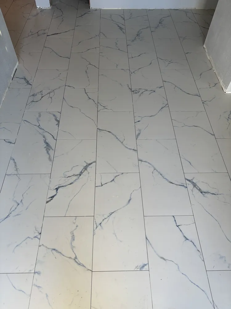 Large-format white marble-look porcelain floor tile with grey veining