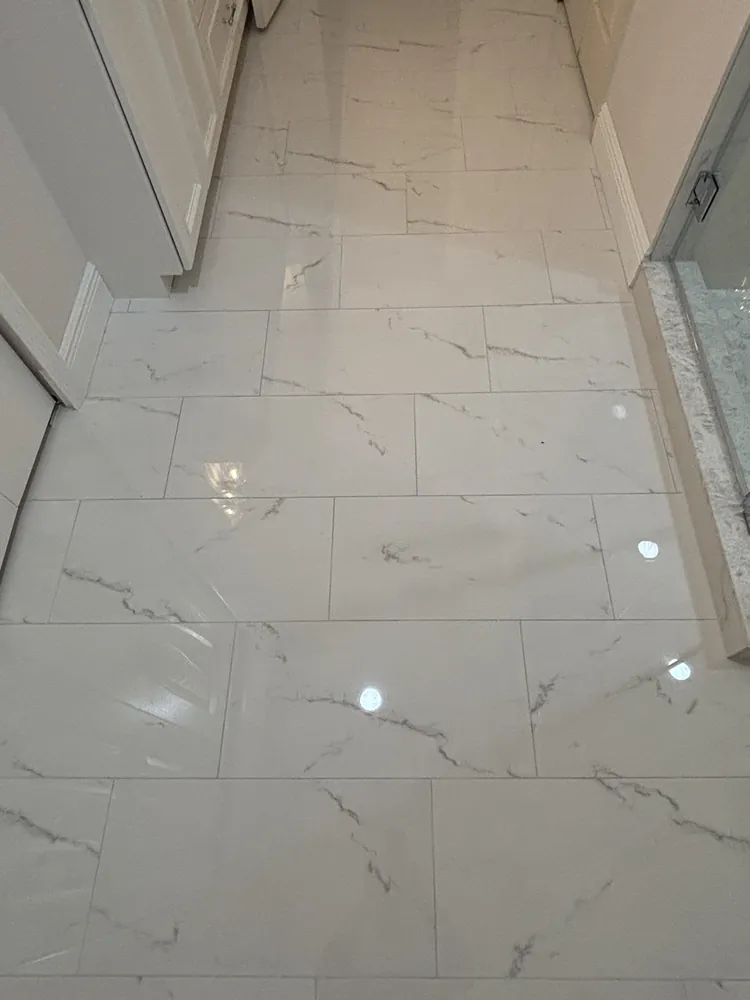Polished marble-look porcelain floor tile running through a hallway
