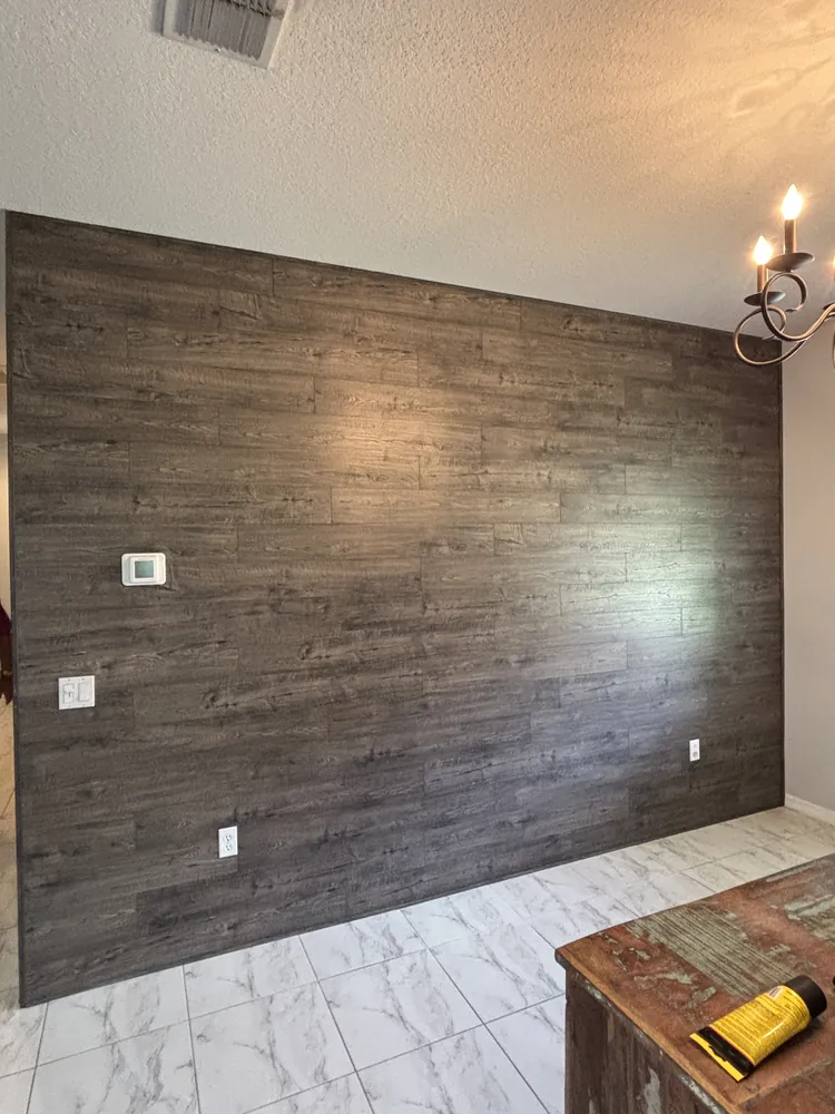 Living room accent wall finished in grey wood planks